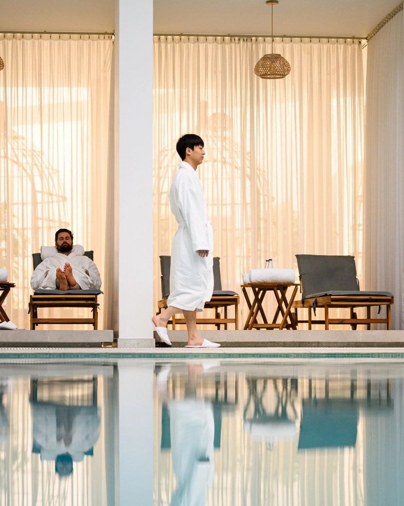 Spa wellness facility with pool and lounge chairs